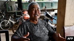 This photo taken on July 9, 2024 shows villager Lim Tomg Eng, who lives next to the proposed Funan Techo canal, speaking during an interview with AFP at his home at Prek Takeo village in Kandal province.