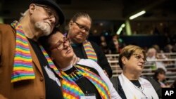 Ed Rowe, left, Rebecca Wilson, Robin Hager and Jill Zundel, react to the defeat of a proposal that would allow LGBT clergy and same-sex marriage within the United Methodist Church at the 2019 Special Session of the General Conference in St. Louis, Mo., Feb. 26, 2019.