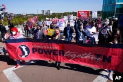 People take part in a Power Together Women's March, Oct. 17, 2020, in Nashville, Tenn. Dozens of women's rallies were planned across the U.S. to signal opposition to President Donald Trump and his policies.