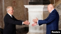 Italian Defense Minister Guido Crosetto, right, greets Canadian Minister of National Defense Bill Blair during the G7 defense ministers meeting in Naples, Italy, Oct. 19, 2024.