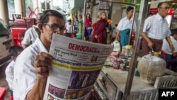 A Myanmar man reads a newspaper reporting on US President-elect Donald Trump's win in the US presidential election in Yangon on November 10, 2016. - Trump's extraordinary US election victory sent shockwaves across the world, as opponents braced for a "dan