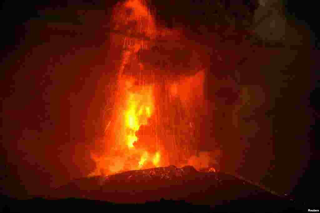 Shinmoedake peak spews molten lava as the peak erupts between Miyazaki and Kagoshima prefectures, southwestern Japan, in this photo released by Kyodo.