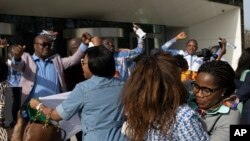 Supporters of Former Ivory Coast President Laurent Gbagbo and former youth minister Charles Ble Goude, celebrate their acquittal outside the International Criminal Court in The Hague, Netherlands, Wednesday, March 31, 2021.