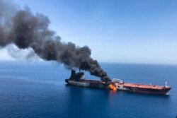FILE - An oil tanker is on fire in the sea of Oman, June 13, 2019. Two oil tankers near the Strait of Hormuz were reportedly attacked, an assault that left one ablaze and adrift as sailors were evacuated from both vessels.