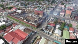FILE - The remains of the Camp Street Prison, after it was destroyed by a fire during a riot, are seen in Georgetown, Guyana, July 10, 2017. Monday's jailbreak at Lusignan Prison is the latest in a series of security breaches in the South American country's penal system
