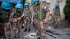 FILE - A U.N. peacekeeper collect weapons from the army headquarters of Ivory Coast's strongman Laurent Gbagbo in Abidjan. 