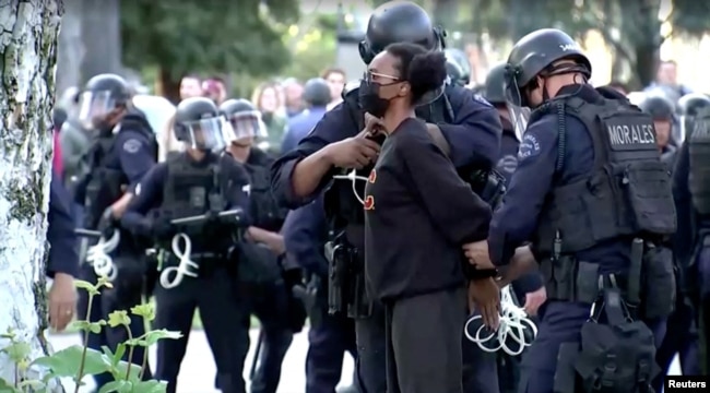 Police arrest a pro-Palestinian protester at USC campus in Los Angeles, California, U.S., April 25, 2024, as seen in this screen grab obtained from a video. (Video obtained by Reuters/via Reuters)