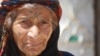 One-hundred-year-old Tamam Shaheen balked at IS orders to veil her face or quit smoking, but in the wake of IS rule, her grandson is now imprisoned and accused of having fought alongside the group, in Sarran, Syria, Aug. 18, 2017. (H. Murdock/VOA)