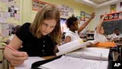 FILE - Students participating in their seventh grade history class lesson at Grant Middle School in Springfield, Ill. According to the 2015 Nation's Report Card math and reading scores slipped for fourth and eighth graders over the last two years.