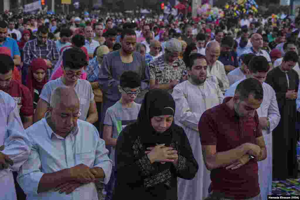 A Muslim woman lines up with Muslim men during Eid prayers in Giza, Egypt, June 15, 2018.