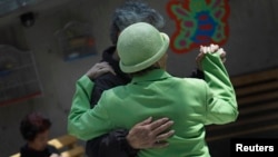 FILE - Patients with Alzheimer's and dementia dance inside the Alzheimer Foundation in Mexico City, April 19, 2012.