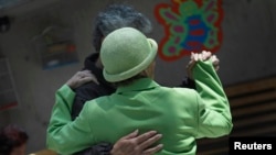 FILE - Patients with Alzheimer's and dementia dance inside the Alzheimer Foundation in Mexico City, April 19, 2012.