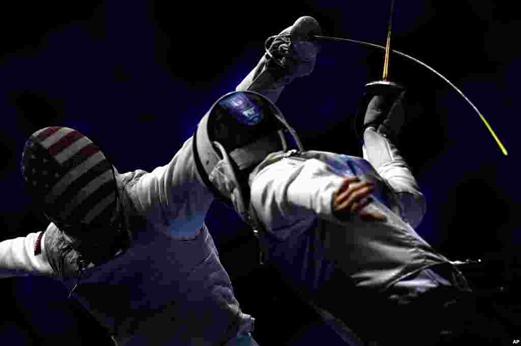 Tamas Meszaros (R) of Hungary and Race Imboden of United States fence during the men&#39;s team foil round of 16 match of the FIE World Fencing Championships in Budapest, Hungary.