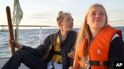 Annika Holm Nielsen (r), and Calle Vangstrup sail in the Oresund strait between Copenhagen and Malmo, Sweden, Sept. 9, 2015.