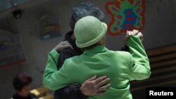 FILE - Patients with Alzheimer's and dementia dance inside the Alzheimer Foundation in Mexico City, April 19, 2012.