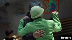 FILE - Patients with Alzheimer's and dementia dance inside the Alzheimer's Foundation in Mexico City, April 19, 2012.