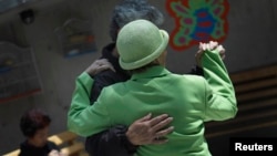 FILE - Patients with Alzheimer's and dementia dance inside the Alzheimer Foundation in Mexico City, April 19, 2012.