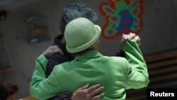 FILE - Patients with Alzheimer's and dementia dance inside the Alzheimer Foundation in Mexico City, April 19, 2012.