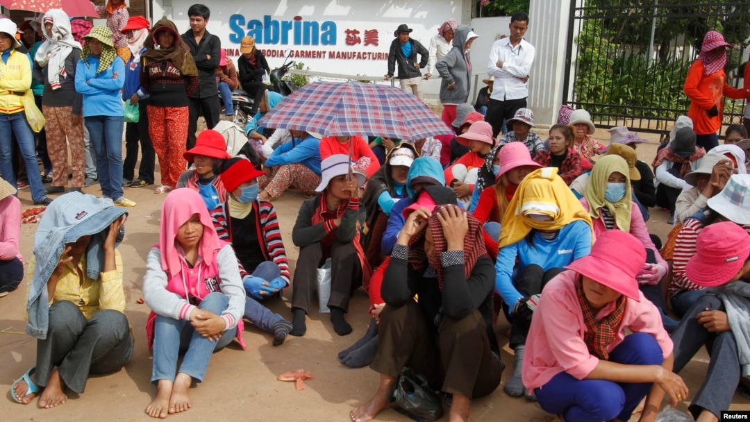 Workers gather during their strike in front of a factory owned by Sabrina (Cambodia) Garment Manufacturing in Kampong Speu province, west of the capital, Phnom Penh, May 30, 2013. 