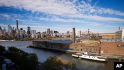 FILE- A rusting ferryboat is docked next to an aging industrial warehouse on Long Island City's Anable Basin in the Queens borough of New York. Amazon said on Feb. 14, 2019 that it will not be building a new headquarters in New York. 