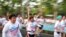 Runners flash the three-finger salute of resistance to authority as they attend the "Run Against Dictatorship" event in Bangkok, Jan. 12, 2020.