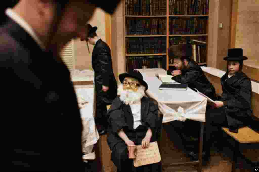 A child dressed in a Purim costume pauses inside a synagogue in Jerusalem, early Friday, March 9, 2012. The Jewish holiday of Purim celebrates the Jews' salvation from genocide in ancient Persia, as recounted in the Scroll of Esther. (AP Photo/Bernat Arma