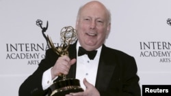 FILE - British producer Julian Fellowes, creator of Downton Abbey, poses with the International Emmy Founders Award backstage at the 43rd International Emmy Awards Gala in Manhattan, New York, Nov. 23, 2015. 