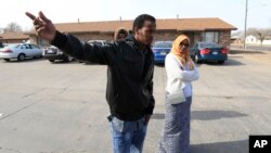 Ifrah Ahmed, right, and Mursal Naleye, left, stand outside the apartments housing Somali refugees that were threatened in a bomb plot in Garden City, Kan., Feb. 3, 2017. 