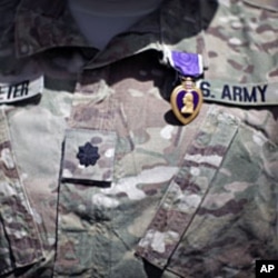 FILE - A Purple Heart medal is seen on the uniform of U.S Army Lt Colonel Alan Streeter after U.S. Secretary of Defense Robert Gates presented the award for wounds he received in combat, during a ceremony at Combat Outpost Andar in Ghazni Province, Afghanistan.