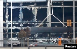 Broken windows seen at the scene of explosions at Zaventem airport near Brussels, Belgium, March 22, 2016.