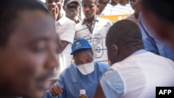 Nurses working with the World Health Organization (WHO) prepare to administer vaccines at the town all of Mbandaka on May 21, 2018 during the launch of the Ebola vaccination campaign.