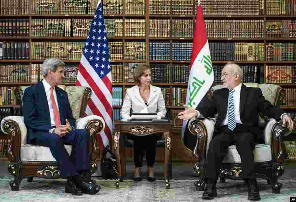 U.S. Secretary of State John Kerry and Iraqi Foreign Minister Ibrahim al-Jaafari have a chat before their official meeting in Baghdad, Sept. 10, 2014.