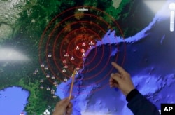 Officers from the Korea Meteorological Administration point at the epicenter of seismic waves in North Korea, at the National Earthquake and Volcano Center of the Korea Meteorological Administration in Seoul, South Korea, Jan. 6, 2016.