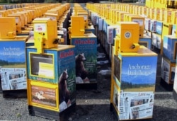 FILE - Hundreds of old newspaper vending machines are shown in a vacant lot near the former offices of the Alaska Dispatch News in Anchorage, Alaska, Sept. 11, 2017.