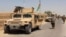 FILE - Afghan National Army troops arrive in the Nad Ali district of southern Helmand province, Aug. 10, 2016. An overnight airstrike in the area reportedly has killed at least 24.