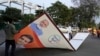Municipal workers remove a hoarding displaying an image of Indian Prime Minister Narendra Modi in Lucknow, in the central Indian state of Uttar Pradesh, on March 16, 2024. India's six-week-long general elections will start on April 19,