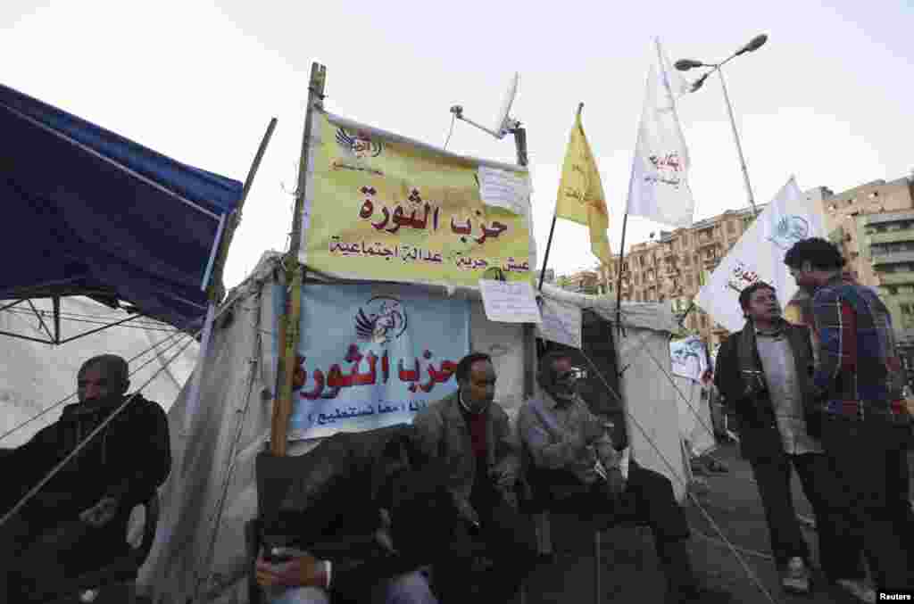 Protesters against Egypt&#39;s President Mohamed Morsi rest in front of a tent named &quot;Revolution Party&quot; at Tahrir Square in Cairo December 17.