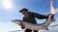 In this Oct. 8, 2010 photo, Matt Balazik gets ready to throw a 70-lb Atlantic sturgeon into the James River near Charles City, Virginia. (AP Photo/Steve Helber)