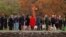 FILE - Families and friends are seen gathered around a memorial at a service in memory of 35 people killed, on the first anniversary of a rampage by a lone gunman in Port Arthur, Tasmania, Australia, April 28, 1997.