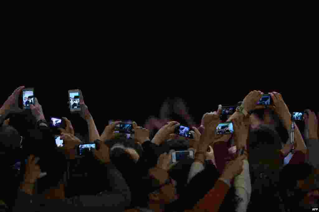 People take pictures of Pope Francis with cameras, mobile phones and tablets during a meeting with members of the Catholic Action at Paul VI audience hall at the Vatican.