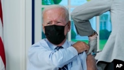 President Joe Biden receives a COVID-19 booster shot during an event in the South Court Auditorium on the White House campus, Sept. 27, 2021, in Washington.