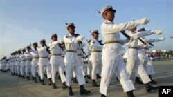 Guard of Honor march in front of city hall to participate in a ceremony to mark 63rd anniversary of Independence Day Tuesday, Jan. 4, 2011, in Naypyitaw, Myanmar. (AP Photo/Khin Maung Win)