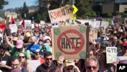 People hold up signs during a rally against hate in Berkeley, California, Aug. 27, 2017. 