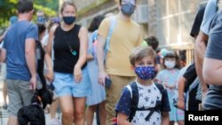 FILE: A child wears a face mask on the first day of New York City schools, amid the coronavirus disease (COVID-19) pandemic in Brooklyn, New York, Sept. 13, 2021.