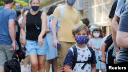 FILE: A child wears a face mask on the first day of New York City schools, amid the coronavirus disease (COVID-19) pandemic in Brooklyn, New York, Sept. 13, 2021.