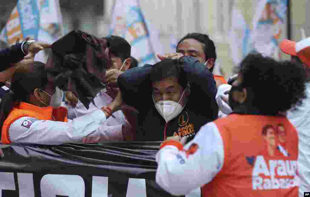 Andres Arauz, presidential candidate for the alliance &quot;Unidos por la Esperanza&quot; reacts after being struck in the head by an object during a rally in Quito, Ecuador, Jan. 26, 2021.