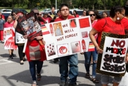 Jonathan Sam of Stillwater, Okla., a Navajo and Zuni native, joins a march to call for justice for missing and murdered indigenous women Friday, June 14, 2019, at the Cheyenne and Arapaho Tribes of Oklahoma in Concho, Okla. (AP Photo/Sue Ogrocki)