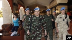 U.N. monitors walk through a hotel in Damascus, April 16, 2012.
