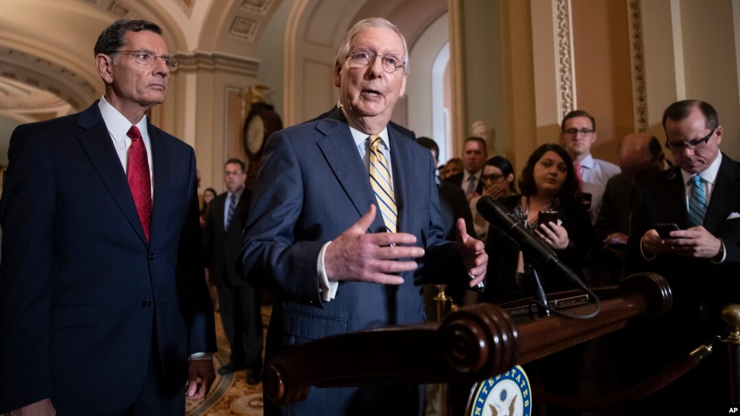 Senate Majority Leader Mitch McConnell, R-Ky., joined at left by Sen. John Barrasso, R-Wyo., speaks to reporters about the political battle for confirmation of President Donald Trump's Supreme Court nominee, Brett Kavanaugh.