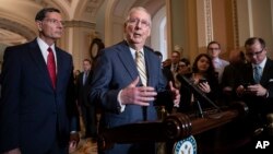 Senate Majority Leader Mitch McConnell, R-Ky., joined at left by Sen. John Barrasso, R-Wyo., speaks to reporters about the political battle for confirmation of President Donald Trump's Supreme Court nominee, Brett Kavanaugh.